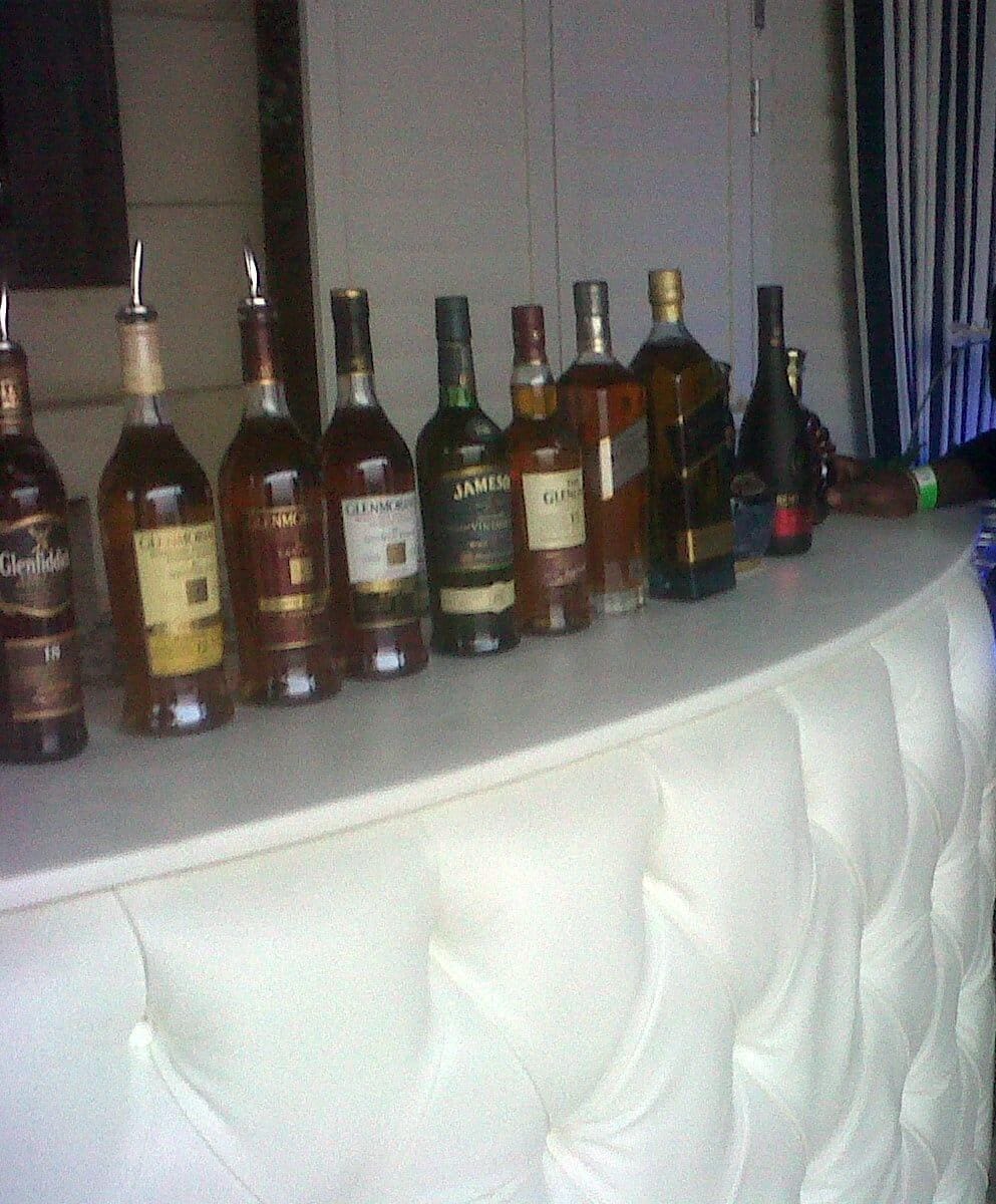 Illuminated mobile bar setup at an outdoor event